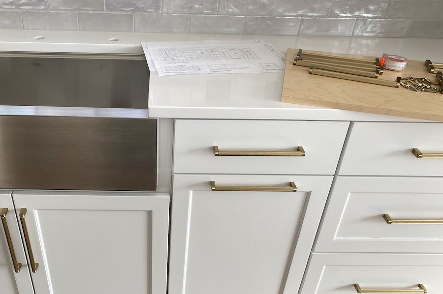 Remodeled white cabinets with brass handles