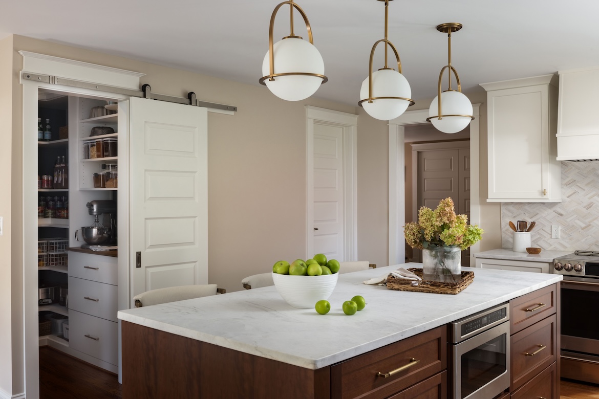 Upscale kitchen with white countertops and updated lighting